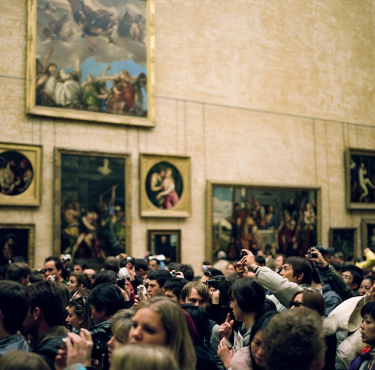 Tourists swarm around the Mona Lisa at the Louvre Museum in Pari